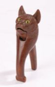 19th Century nutcracker, of a cat carved in soft wood with big bright yellow glass eyes, 16.5cm