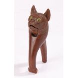 19th Century nutcracker, of a cat carved in soft wood with big bright yellow glass eyes, 16.5cm