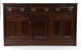 George II oak dresser base, of slender proportions, circa 1740, the rectangular top above three