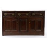 George II oak dresser base, of slender proportions, circa 1740, the rectangular top above three