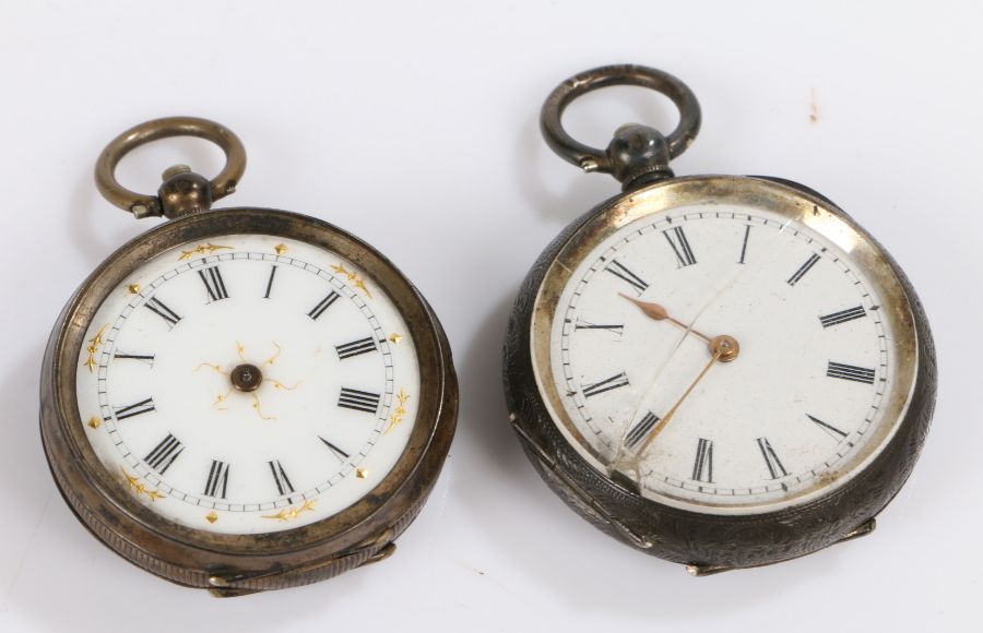 Two silver pocket watches, roman numerals on a white dial with gilt accents to the center and