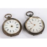 Two silver pocket watches, roman numerals on a white dial with gilt accents to the center and