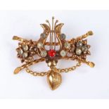 19th Century brooch, with a harp set with paste stone flanked by flower heads and twisted bars, 52mm