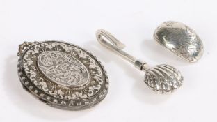 Silver locket with foliate decoration, silver napkin holder in the form of a shell and a singular