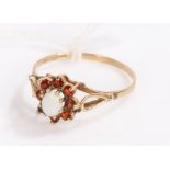 9 carat gold garnet and opal ring, with a central opal surrounded by eight garnets, ring size R