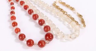 Costume jewellery to include two necklaces one with red stones, and a yellow metal bracelet (3)