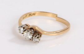 18 carat gold and diamond ring, the head set with three diamonds in a crossover style, band cut, 2.