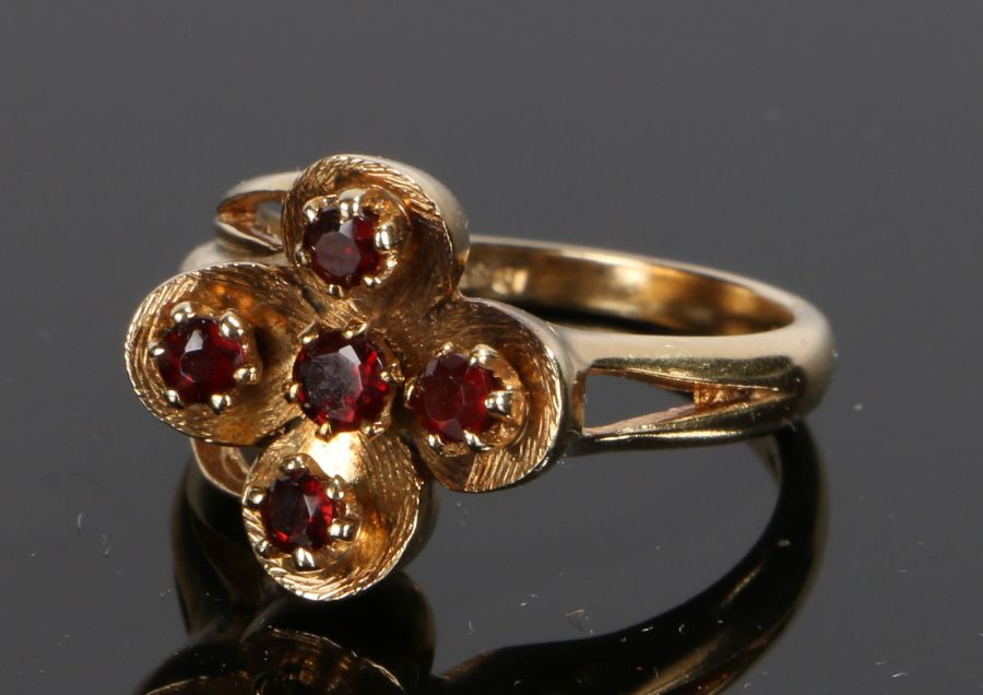 9 carat gold garnet set ring, with five garnets to the foliate stylised head, ring size N