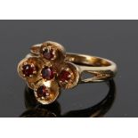 9 carat gold garnet set ring, with five garnets to the foliate stylised head, ring size N