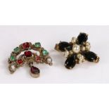 Two brooches one set with green and red stones on yellow metal the other is set with simulated