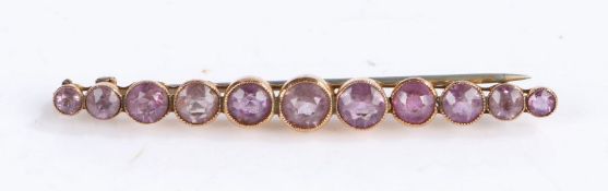 9 carat gold and amethyst bar brooch, eleven amethysts set on 9 carat gold, gross weight 3.4 grams