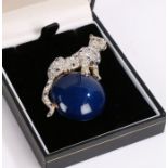 Butler and Wilson brooch in the form of a leopard sitting on top of a blue ball