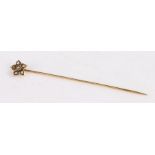 Yellow metal stick pin set with 6 pearls arranged in a flower pattern