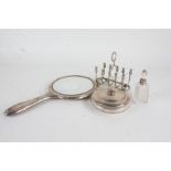Silver handled hand mirror with cast foliate decoration, silver lidded clear glass powder bowl and
