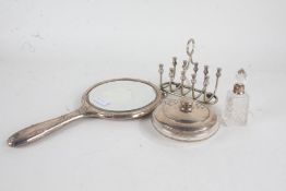 Silver handled hand mirror with cast foliate decoration, silver lidded clear glass powder bowl and