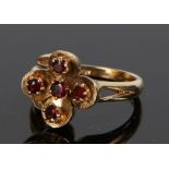 9 carat gold garnet set ring, with five garnets to the foliate stylised head, ring size N gross