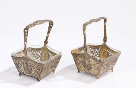 Pair of Continental 800 silver sweetmeat baskets, the pierced swing handles above pierced floral