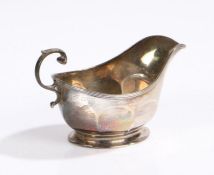 George VI silver sauceboat, Chester marks rubbed, maker Walker & Hall, with double scroll handle and