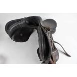 Black leather horse riding saddle, with a pair of stirrups