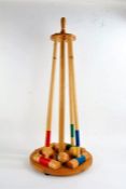 Wooden croquet set, including four mallets and four balls, on stand, 93cm high
