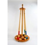 Wooden croquet set, including four mallets and four balls, on stand, 93cm high