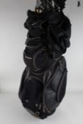 MacGregor golf clubs and others, with Dunlop woods and a driver, with golf bag