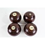 Taylor Rolph & Co., four lignum vitae lawn bowls, each with ivory discs, three initialled with an '