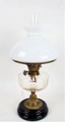 Victorian brass table oil lamp, with white opaque glass shade above a glass reservoir, 55cm high