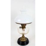 Victorian brass table oil lamp, with white opaque glass shade above a glass reservoir, 55cm high