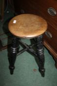 Elm seated stool, having circular seat above a black painted base (AF), 52cm high