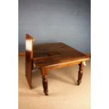 Late Victorian extending dining table, with chamfered corners, raised on fluted legs and castors,