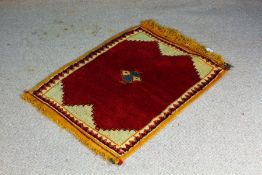 Persian Gabbeh rug, the central cream panel with a red medallion and small multi coloured lozenge,