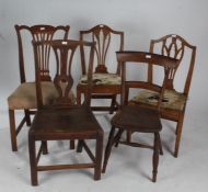 Three 19th century elm dining chairs, a mahogany similar, each with pierced slat back rests, and