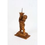 Continental giltwood pricket candlestick, modelled as a putto holding a cornucopia, 18cm wide, 35.