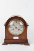 Early 20th Century mahogany mantel clock, the arched case having a silvered dial with Roman