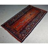 Shahsevan type rug, the hand knotted peach ground with three multi coloured lozenges, flanked by