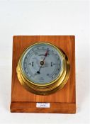 Sestrel brass cased marine barometer, the silvered dial inscribed "CAP'T O.M. WATTS LTD. LONDON", on