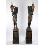 Pair of Egyptian revival metal torchere's, the figural lamps with an Egyptian figure holding a