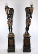 Pair of Egyptian revival metal torchere's, the figural lamps with an Egyptian figure holding a