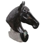 Patinated sculpture of a Horse head, the head in black above a horse to the rocky plinth base,