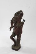 African carved wooden figure, in the form of a hunter, with animal draped over one shoulder and