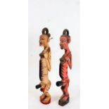 Two African carved and painted fertility figures, modelled in a standing position, each with deep