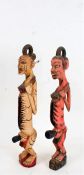 Two African carved and painted fertility figures, modelled in a standing position, each with deep