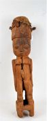 West African carved figure with animal skin drum to the head, 84cm high