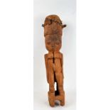 West African carved figure with animal skin drum to the head, 84cm high