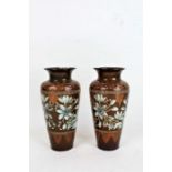 Pair of Victorian Doulton Lambeth stoneware vases, the cylindrical vases painted with white