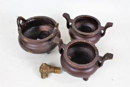 Three Chinese metal censers, each of cylindrical form, with carrying handles and raised on three