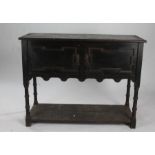 Jacobean style oak dresser base, having a pair of doors above a pot shelf, 122cm wide x 93.5cm high