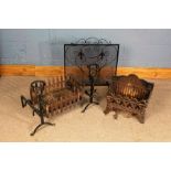 Two cast iron fire baskets, one in the gothic revival taste with a pair of dogs, and a wrought