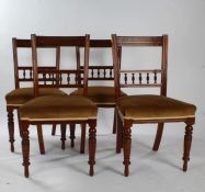 Set of four late Victorian dining chairs, with rail back and spindle back rests, raised on ring